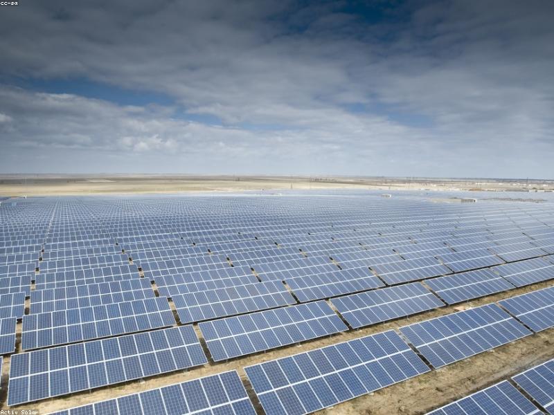 Workers installing solar panels on a rooftop