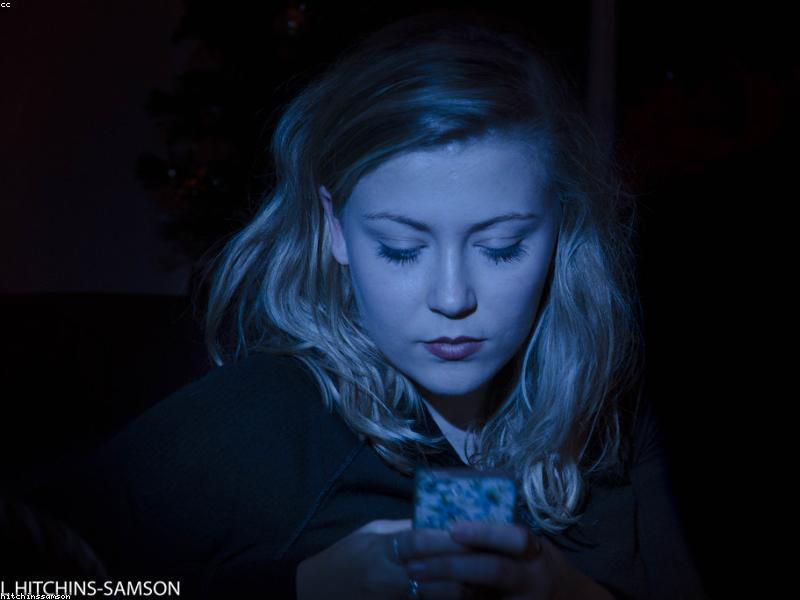 Person looking at phone in bed
