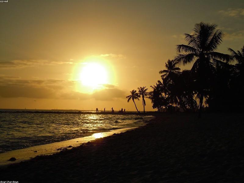 Couple watching sunset at Mallory Square in Key West with performers