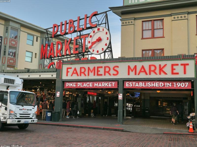 Couple exploring Pike Place Market with fresh flowers and produce